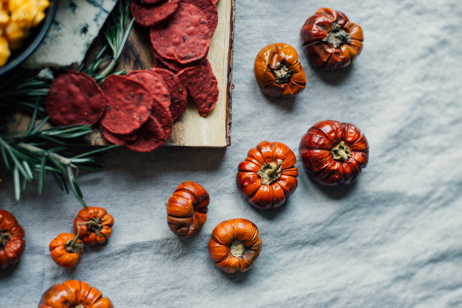 mini dried pumpkins on linen tablecloth