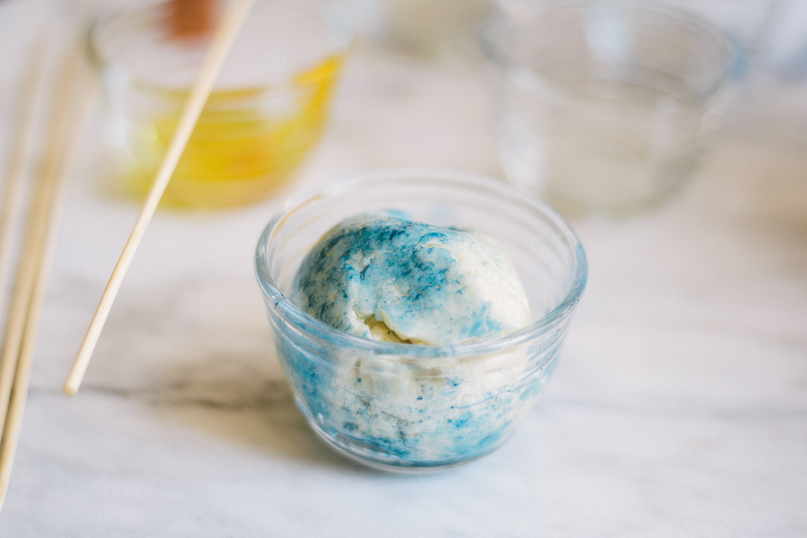 essential oil and natural food dye mixed with home made play dough in glass bowl