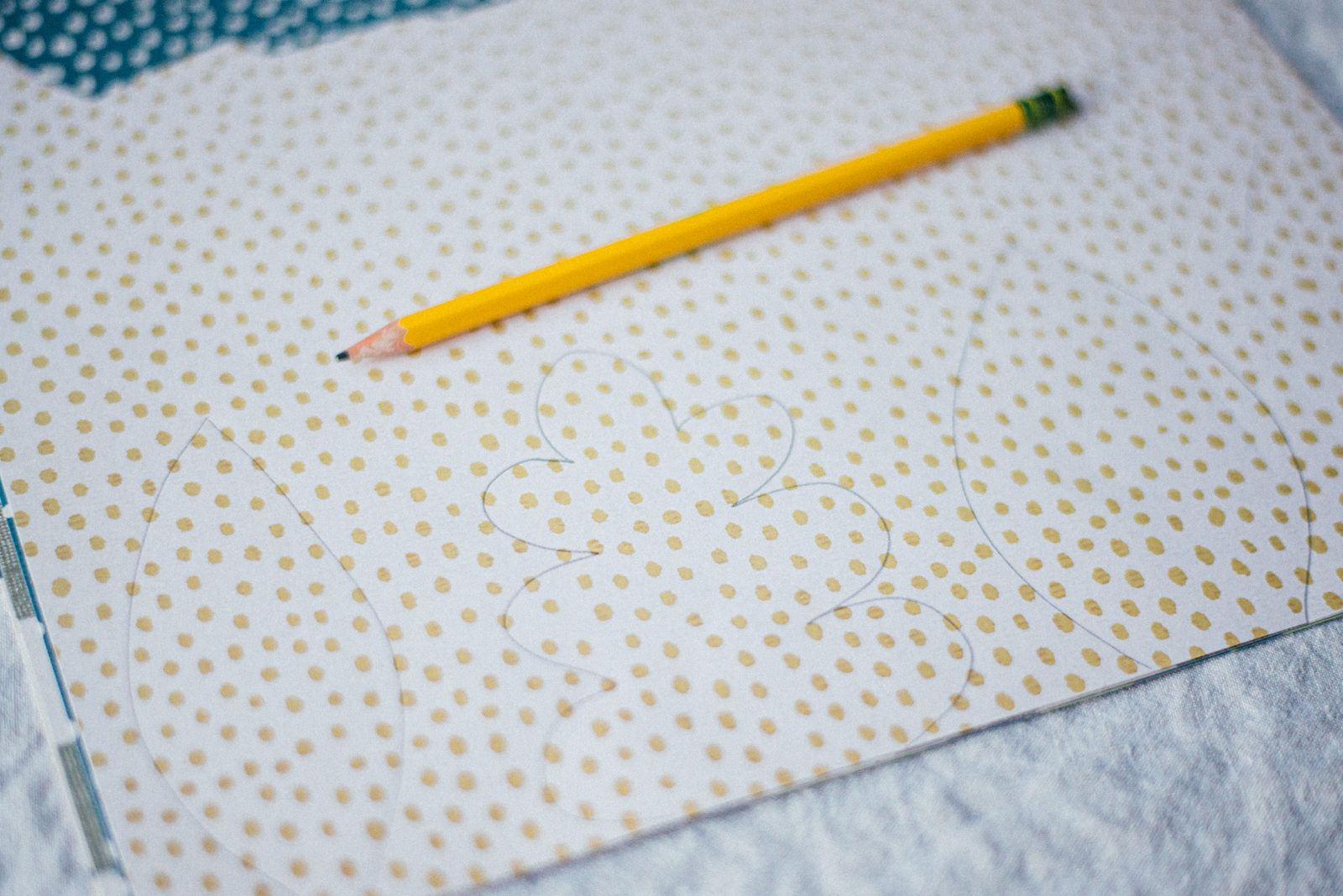 tracing leaves with pencil on colorful craft paper