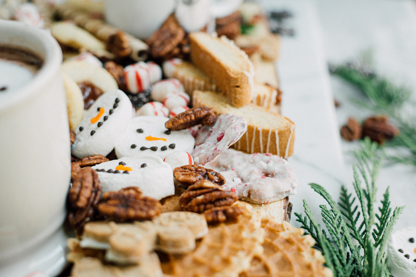 marshmallow hot chocolate snowmen on dessert board