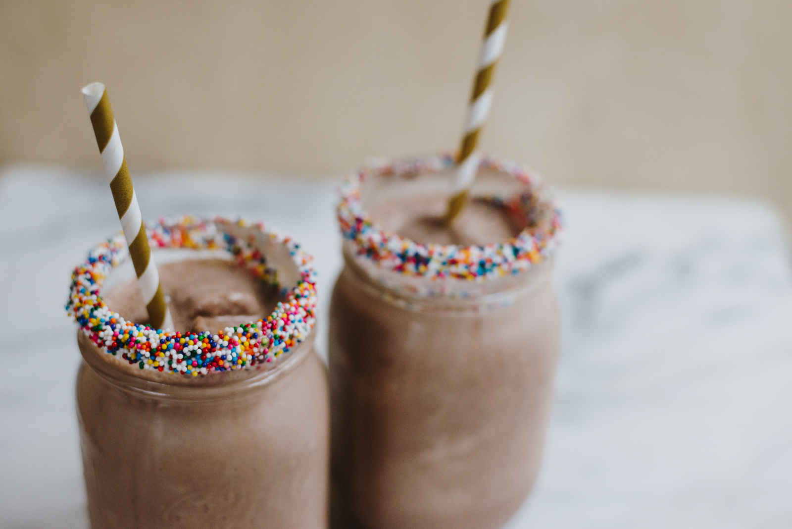 sprinkle milkshakes in mason jars with gold striped straws