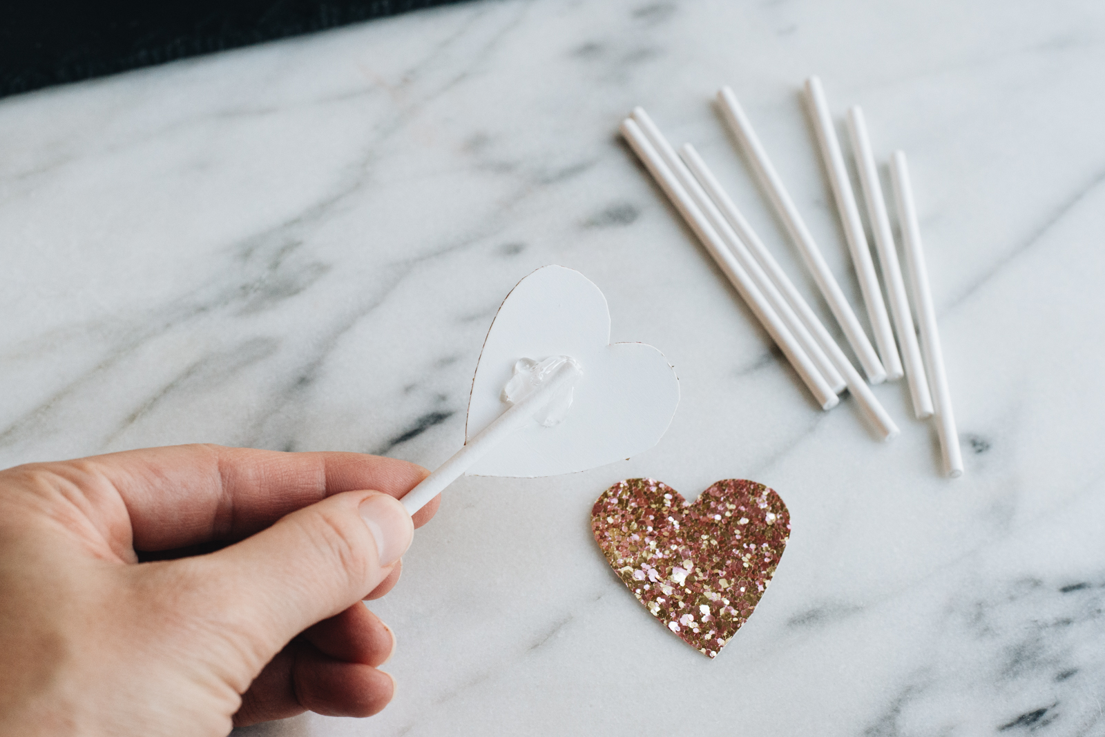 hot glue on the back of glitter paper hearts for cupcake toppers