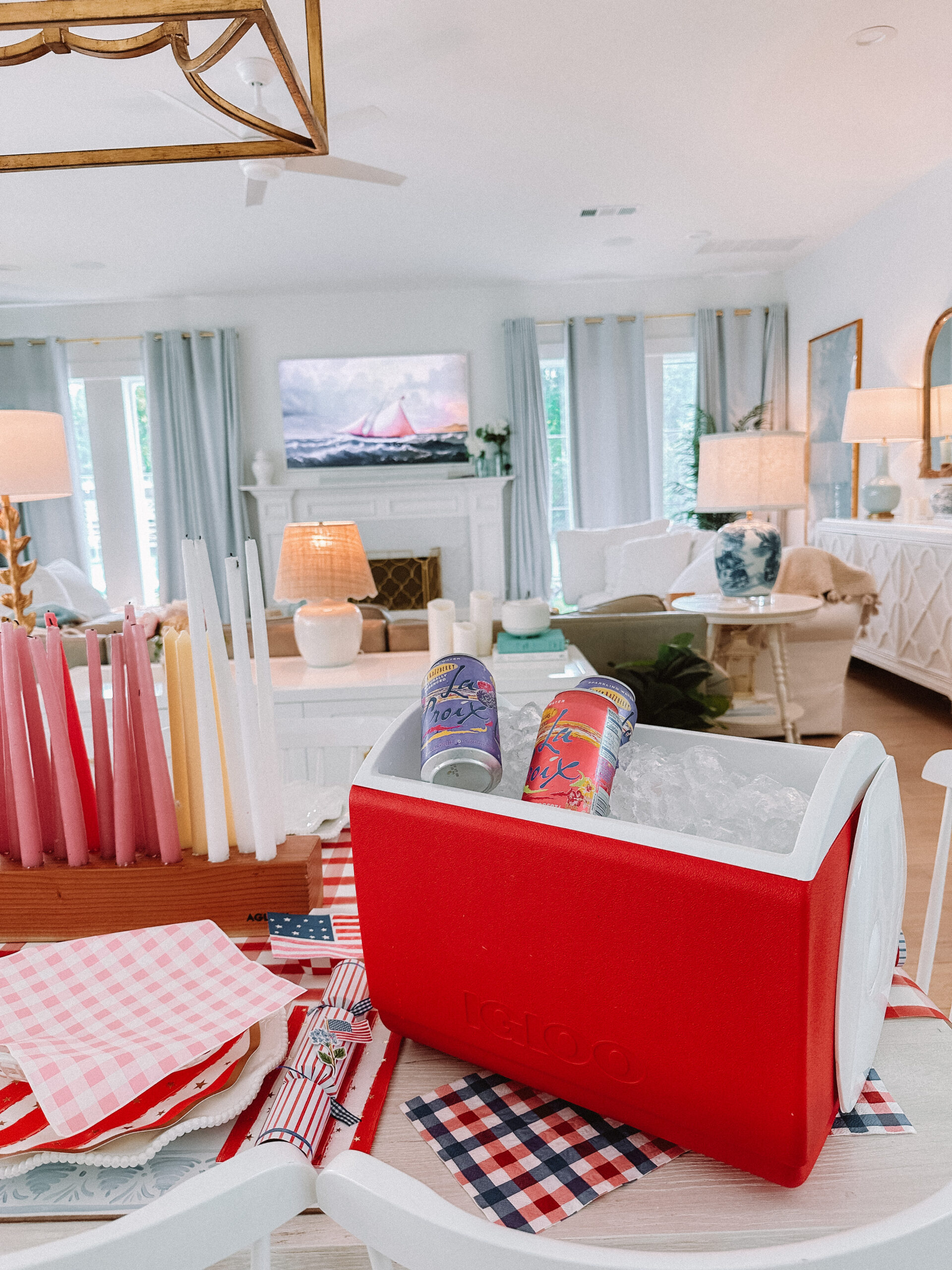 casey wiegand 4th of july long candle holder for parties 4th of July Table Setting Red Gingham Table Runner Flag Plates Scalloped Plates Wood Candle Holder Star Candles Set Stanley Cup in Pool Patriotic Dinner Table Family 4th of July Celebration 4th of July Backyard Party